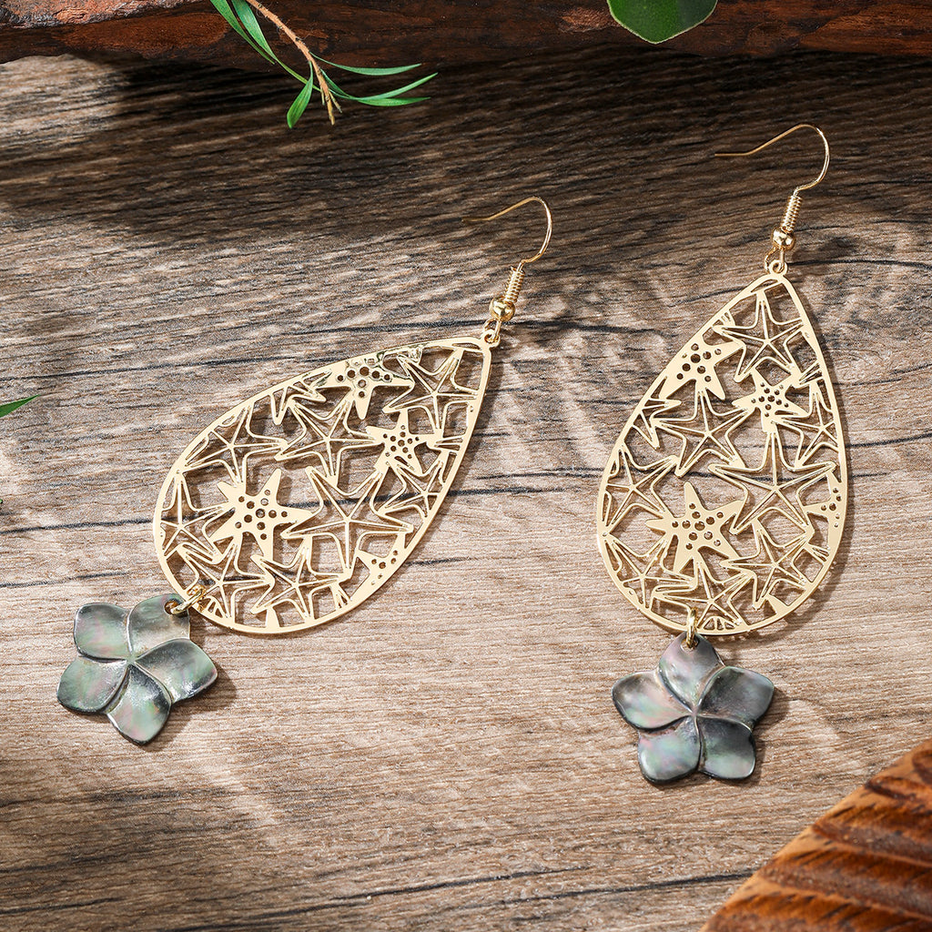 Carved Starfish Teardrop Earrings Sustained With A Black Lip Shell Plumeria Flower