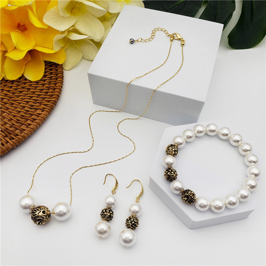 Set Of Bracelet, Earrings And Necklace With Pearls In Different Colors And Gold-Black Hollow Balls