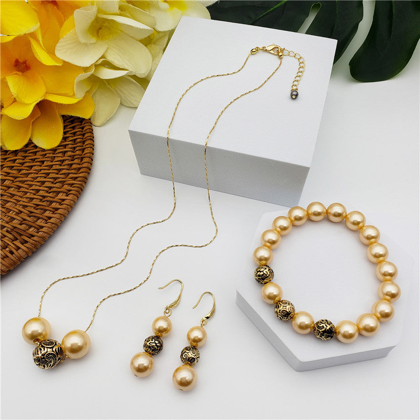 Set Of Bracelet, Earrings And Necklace With Pearls In Different Colors And Gold-Black Hollow Balls