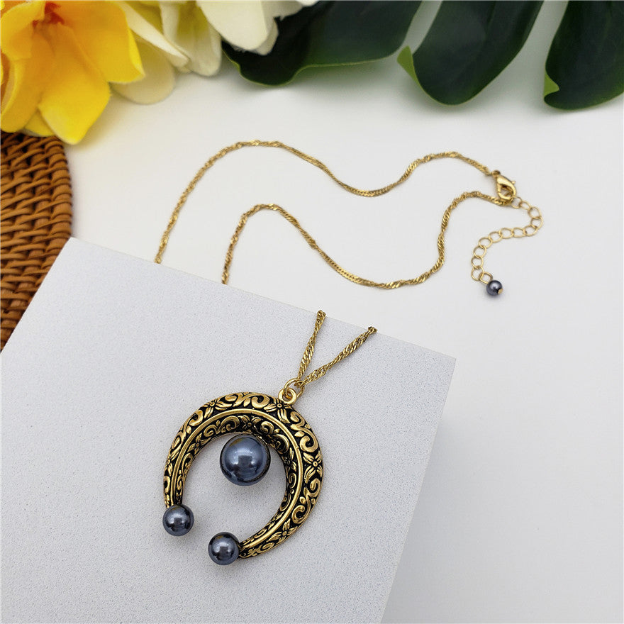 Set Of Petrol Pearl Stud Earrings And Carved Horseshoe Necklace In Silver/Gold With Petrol Pearl