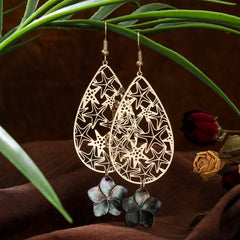 Carved Starfish Teardrop Earrings Sustained With A Black Lip Shell Plumeria Flower