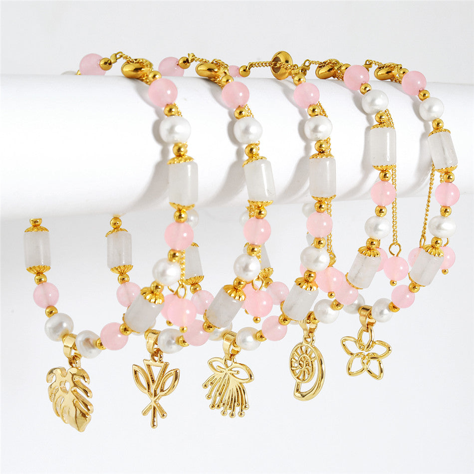 Pearl Bracelet With Light Pink Pearls And Golden Beads In Different Hawaiian Charms