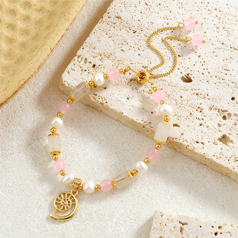 Pearl Bracelet With Light Pink Pearls And Golden Beads In Different Hawaiian Charms