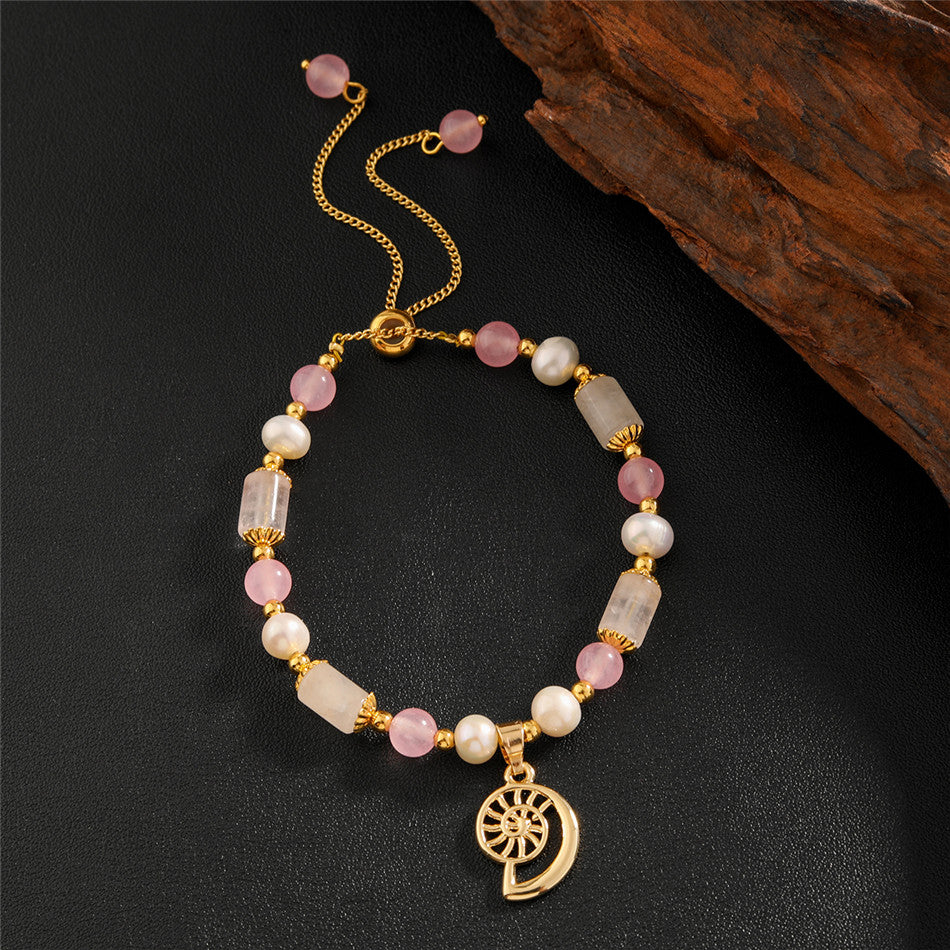 Pearl Bracelet With Light Pink Pearls And Golden Beads In Different Hawaiian Charms