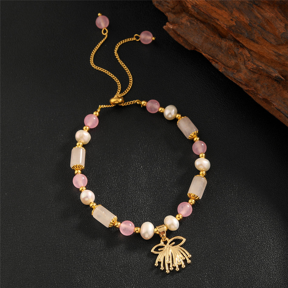 Pearl Bracelet With Light Pink Pearls And Golden Beads In Different Hawaiian Charms