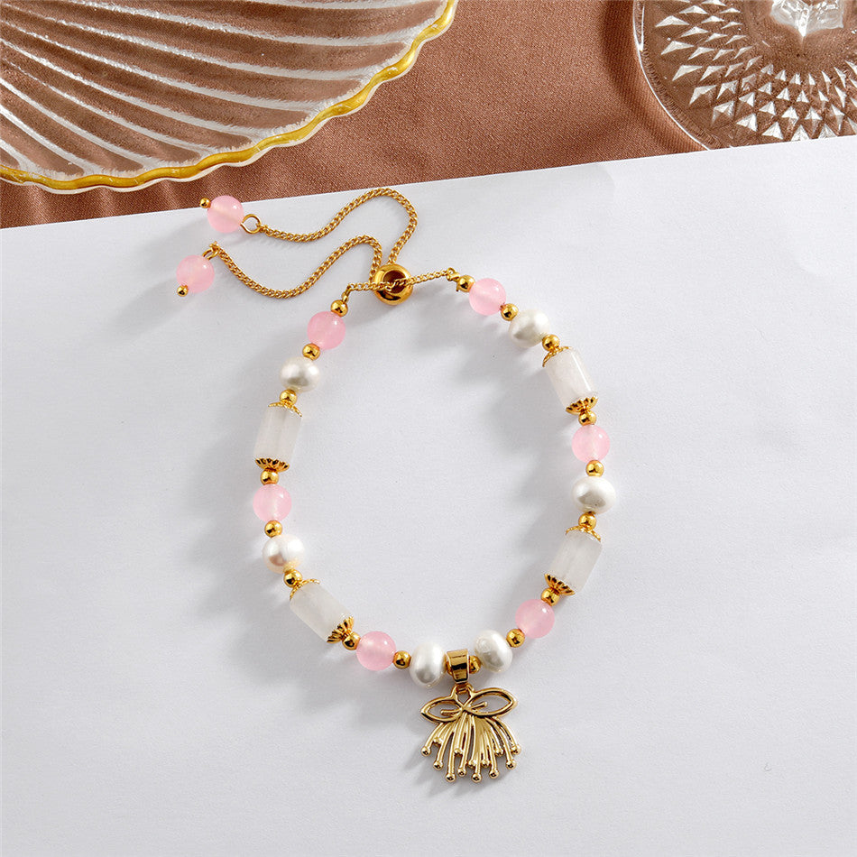 Pearl Bracelet With Light Pink Pearls And Golden Beads In Different Hawaiian Charms