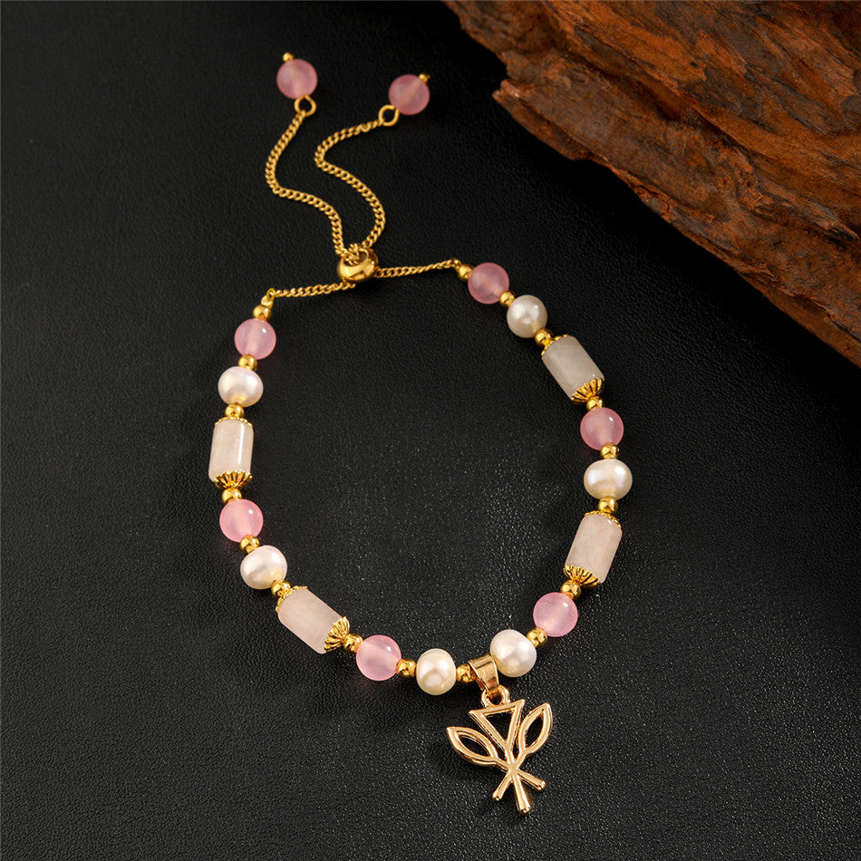 Pearl Bracelet With Light Pink Pearls And Golden Beads In Different Hawaiian Charms