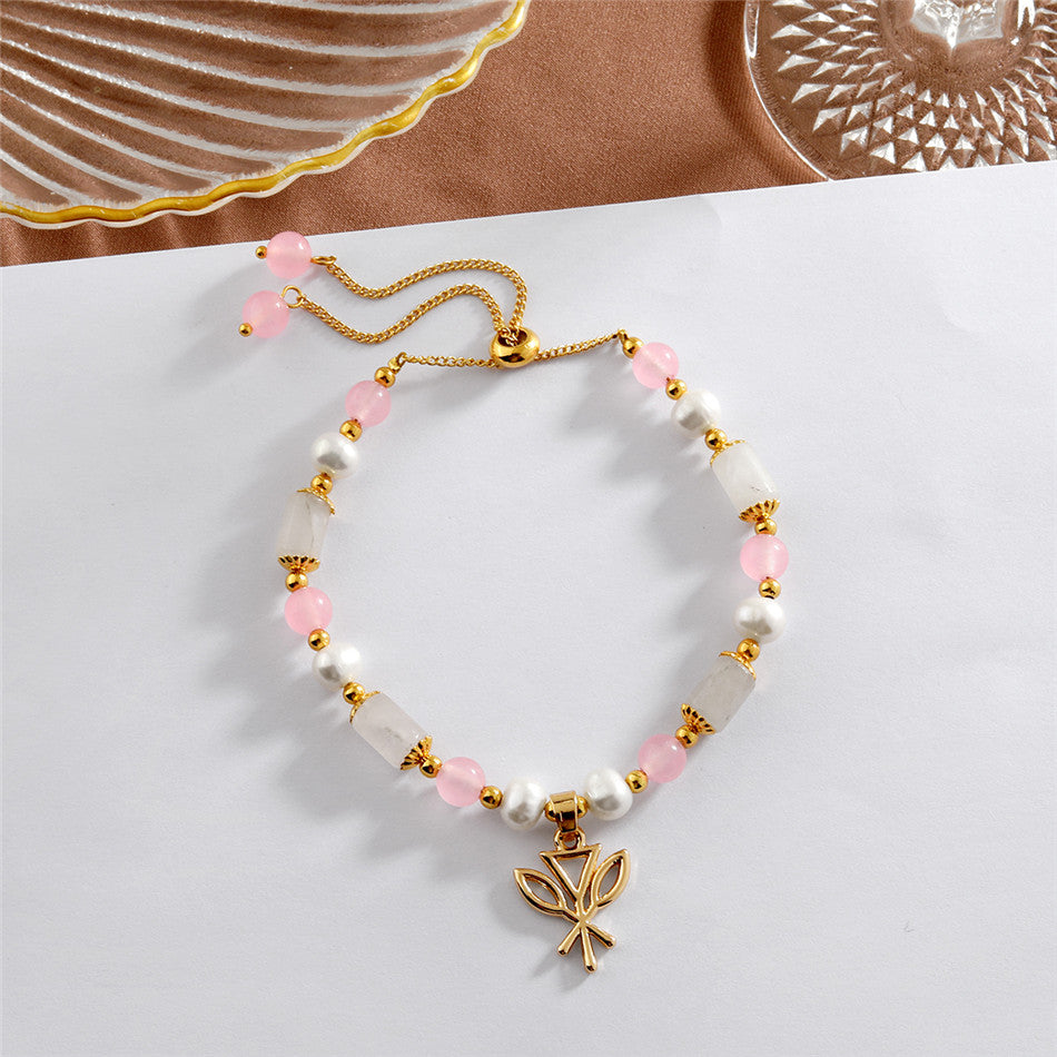 Pearl Bracelet With Light Pink Pearls And Golden Beads In Different Hawaiian Charms