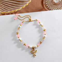 Pearl Bracelet With Light Pink Pearls And Golden Beads In Different Hawaiian Charms