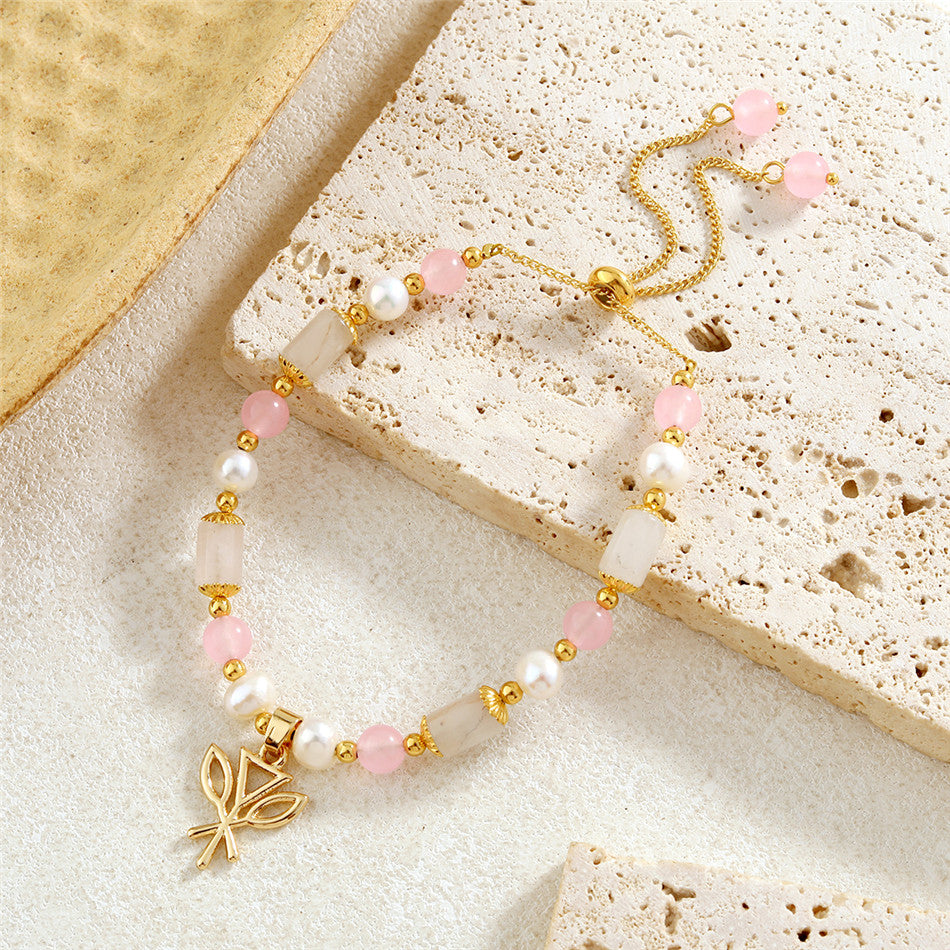 Pearl Bracelet With Light Pink Pearls And Golden Beads In Different Hawaiian Charms