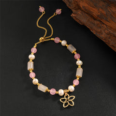 Pearl Bracelet With Light Pink Pearls And Golden Beads In Different Hawaiian Charms