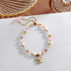 Pearl Bracelet With Light Pink Pearls And Golden Beads In Different Hawaiian Charms