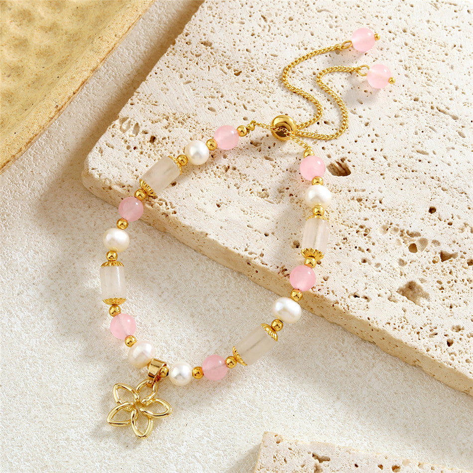 Pearl Bracelet With Light Pink Pearls And Golden Beads In Different Hawaiian Charms