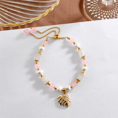 Pearl Bracelet With Light Pink Pearls And Golden Beads In Different Hawaiian Charms