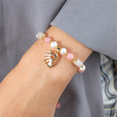 Pearl Bracelet With Light Pink Pearls And Golden Beads In Different Hawaiian Charms