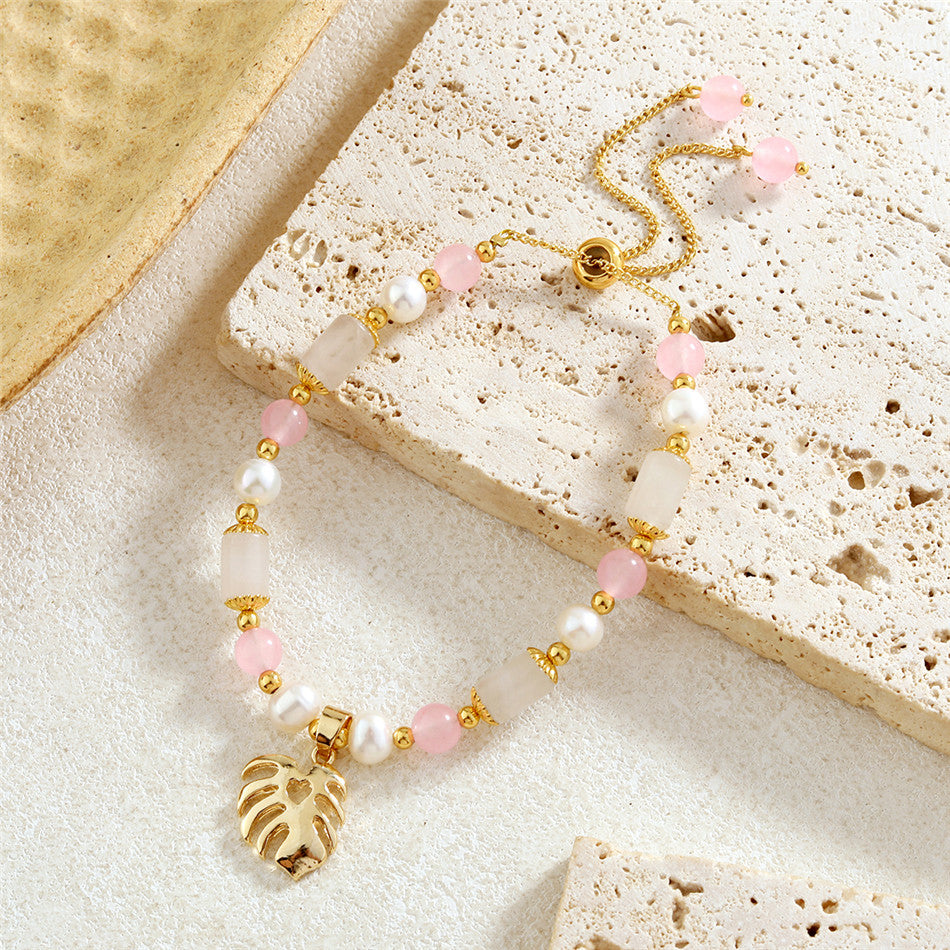 Pearl Bracelet With Light Pink Pearls And Golden Beads In Different Hawaiian Charms