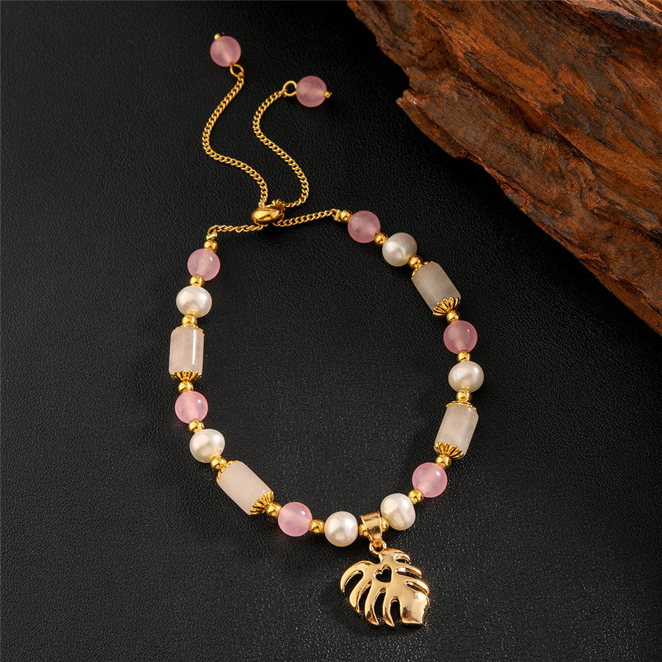 Pearl Bracelet With Light Pink Pearls And Golden Beads In Different Hawaiian Charms