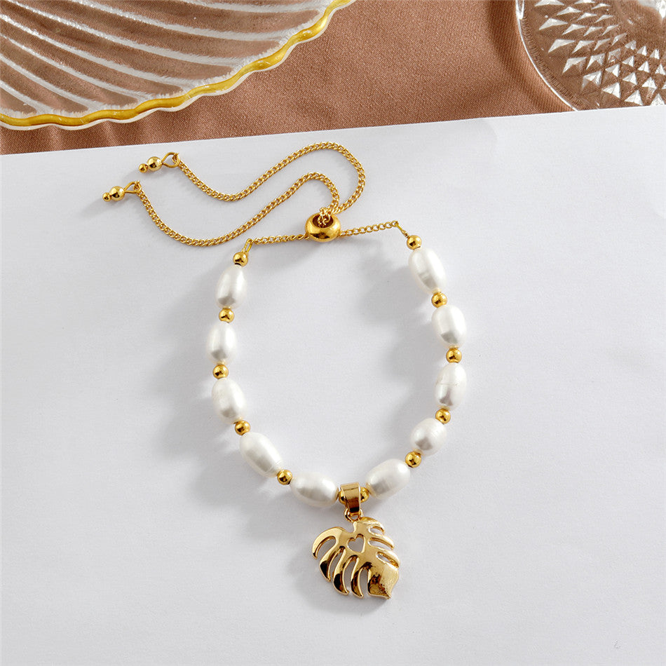 White Oval Pearls And Golden Beads Bracelet In Different Hawaiian Charms