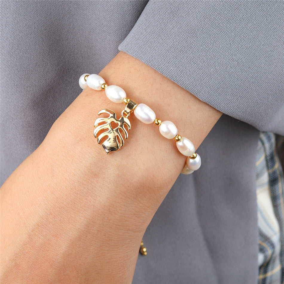 White Oval Pearls And Golden Beads Bracelet In Different Hawaiian Charms