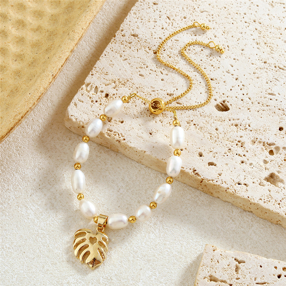 White Oval Pearls And Golden Beads Bracelet In Different Hawaiian Charms