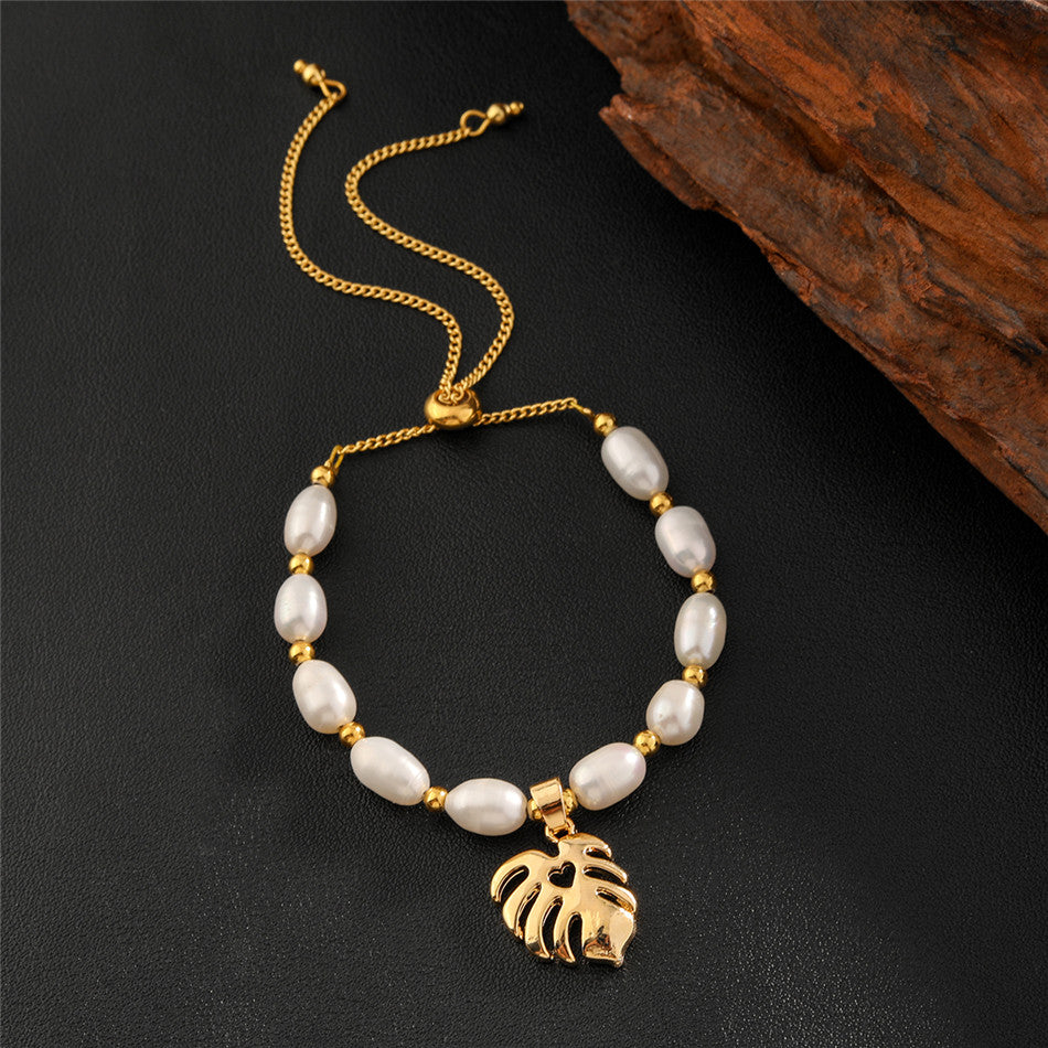 White Oval Pearls And Golden Beads Bracelet In Different Hawaiian Charms