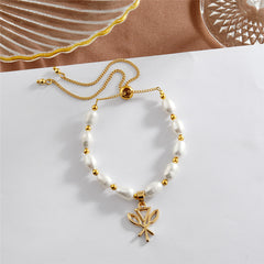 White Oval Pearls And Golden Beads Bracelet In Different Hawaiian Charms