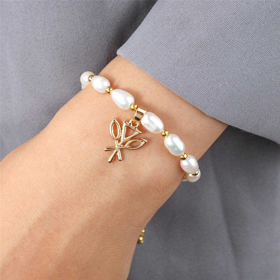 White Oval Pearls And Golden Beads Bracelet In Different Hawaiian Charms