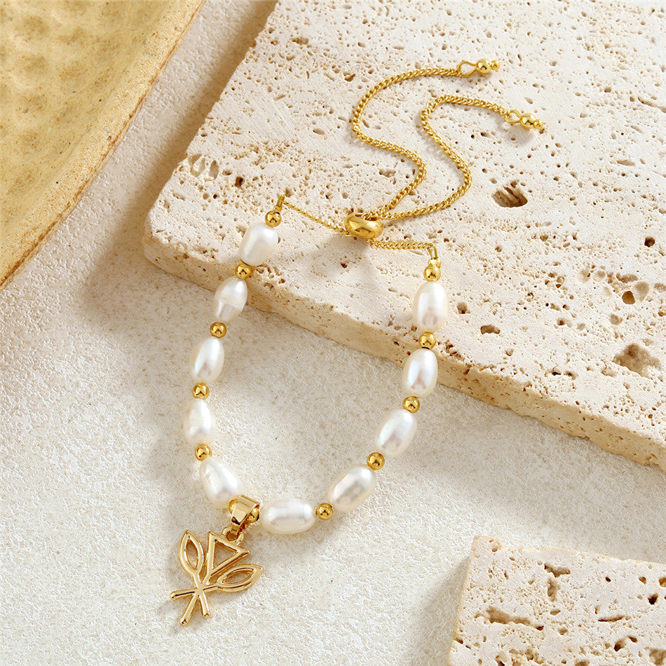 White Oval Pearls And Golden Beads Bracelet In Different Hawaiian Charms