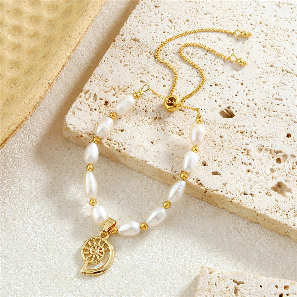 White Oval Pearls And Golden Beads Bracelet In Different Hawaiian Charms