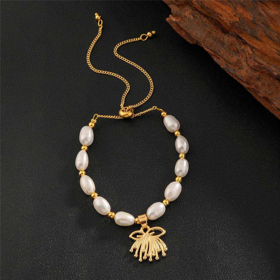 White Oval Pearls And Golden Beads Bracelet In Different Hawaiian Charms