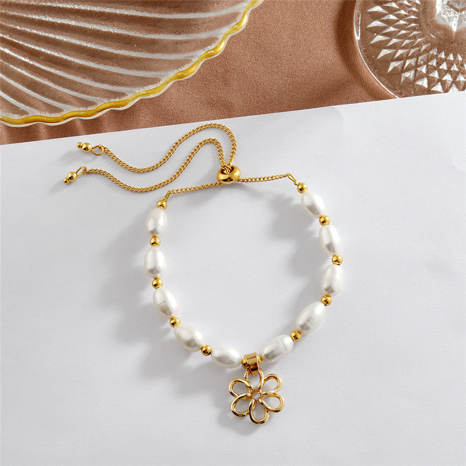 White Oval Pearls And Golden Beads Bracelet In Different Hawaiian Charms