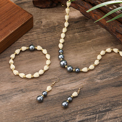 Set Of Bracelet, Drop Earrings And Necklace With Ivory Color Pikake Flower Beads, Golden Brass Beads And Petrol Pearl