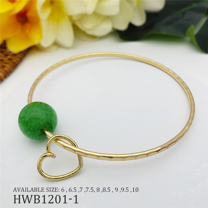 Bracelet With A Green Bead And Heart Charm