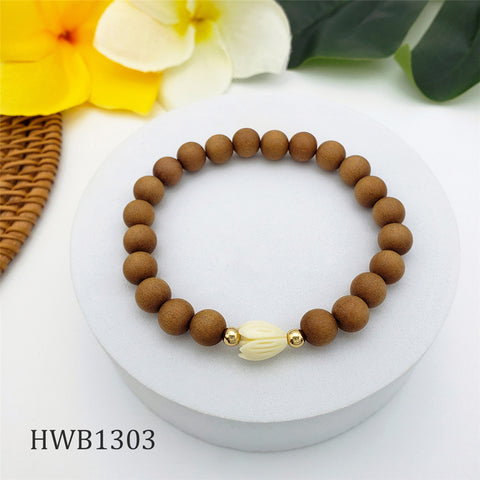 Hawaiian Sandalwood Bead Bracelet With Golden And An Ivory Color Pikake Flower Bead