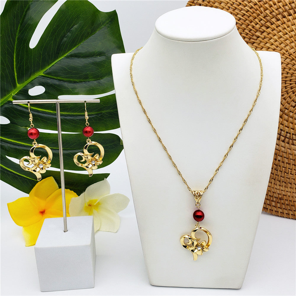 Set Of A Heart Carrying Plumeria Flower Centered With White Zircon Earrings And Necklace In Sliver & Gold Sustained With A Pearl In Different Colors