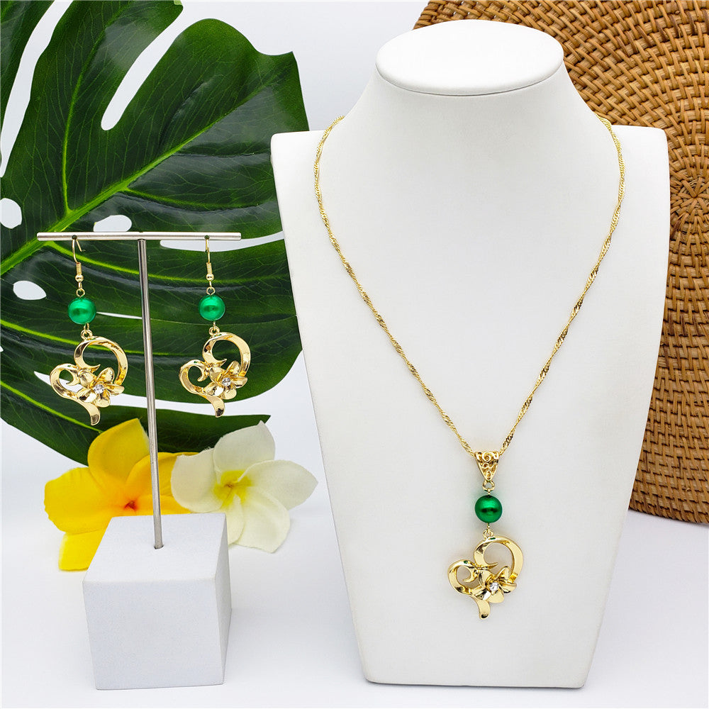 Set Of A Heart Carrying Plumeria Flower Centered With White Zircon Earrings And Necklace In Sliver & Gold Sustained With A Pearl In Different Colors