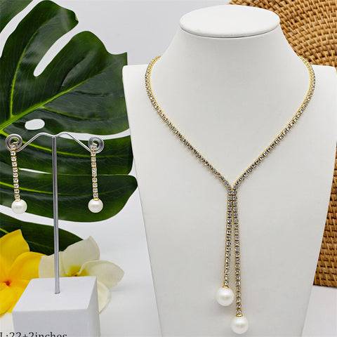 Set Of White Zircons Earrings And Necklace Sustained With A White Pearl