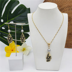 Set Of Hawaiian Carved Hibiscus Flower And Leaves Earrings And Necklace Sustained With A Pearl In Different Colors