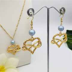 Set Of Infinity Carved Heart Earrings And Necklace Sustained With A Pearl In Different Colors