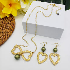 Set Of Carved Heart Earrings And Carved Heart Infinity Necklace Sustained With A Pearl In Different Colors