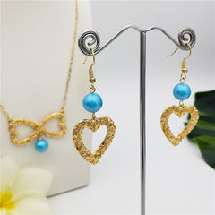 Set Of Carved Heart Earrings And Carved Heart Infinity Necklace Sustained With A Pearl In Different Colors