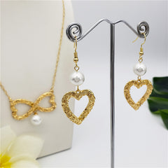 Set Of Carved Heart Earrings And Carved Heart Infinity Necklace Sustained With A Pearl In Different Colors