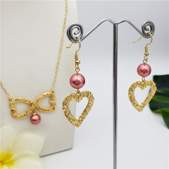 Set Of Carved Heart Earrings And Carved Heart Infinity Necklace Sustained With A Pearl In Different Colors