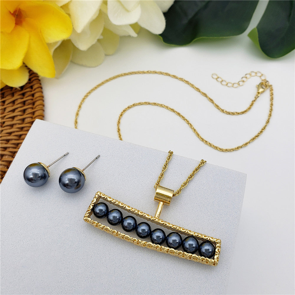 Set Of Petrol Pearl Stud Earrings And Carved Horizontal Bar Necklace Filled With Petrol Pearls