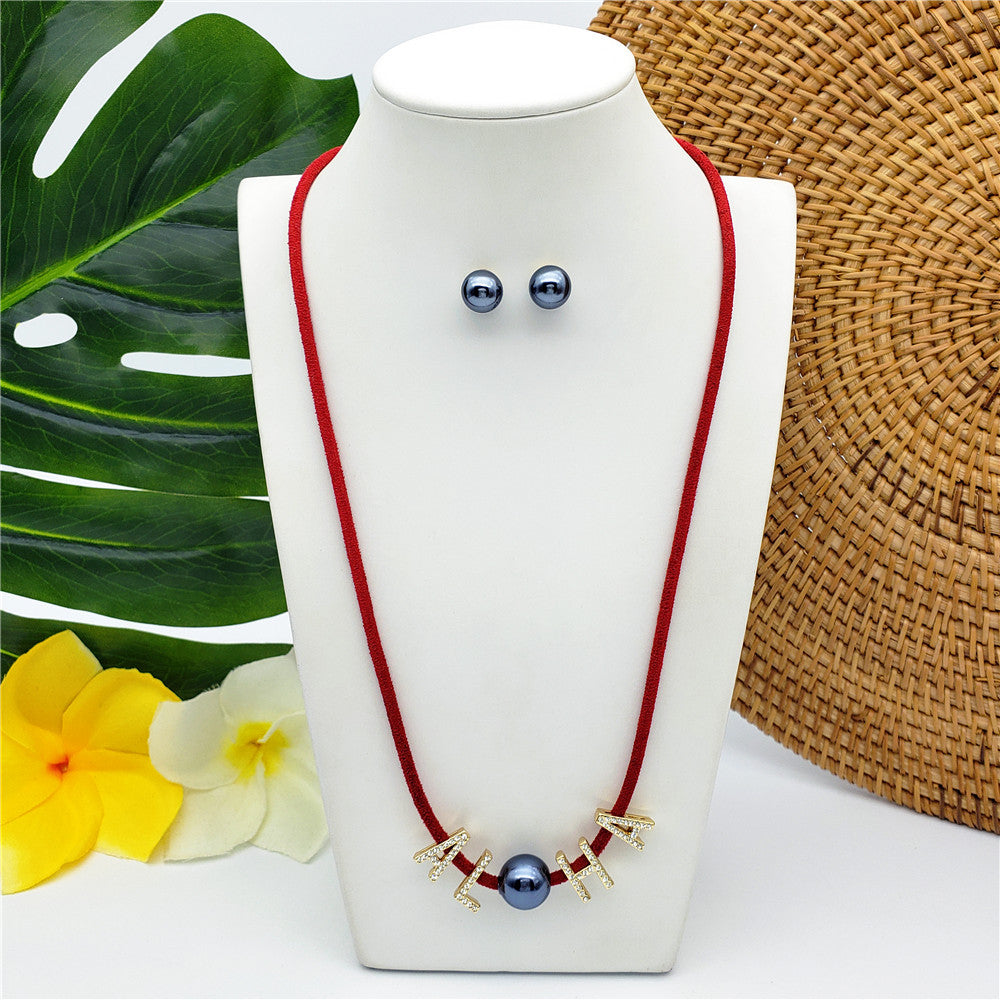 Set Of Petrol Pearl Stud Earrings And Leather Necklace In Different Colors With The Name Of An Island And Petrol Pearl