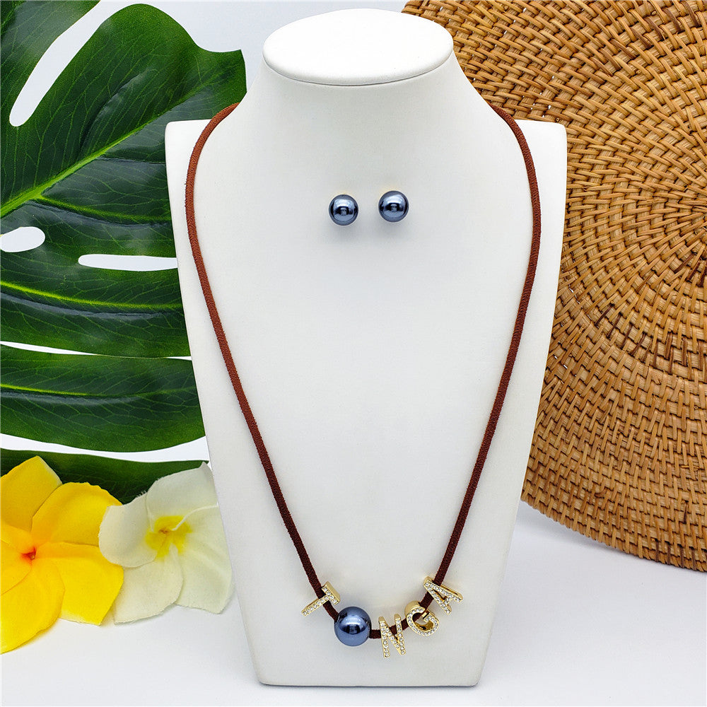 Set Of Petrol Pearl Stud Earrings And Leather Necklace In Different Colors With The Name Of An Island And Petrol Pearl