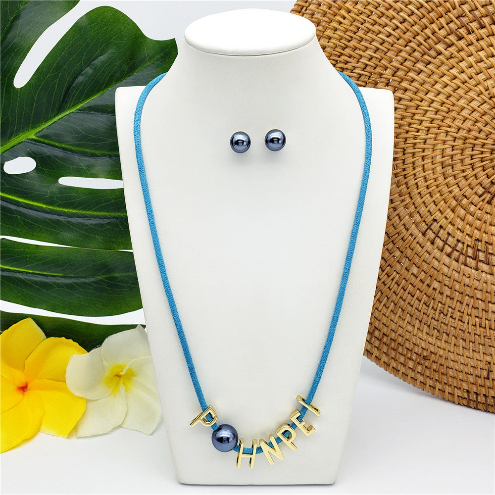 Set Of Petrol Pearl Stud Earrings And Leather Necklace In Different Colors With The Name Of An Island And Petrol Pearl