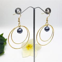 Double Moon Earrings Sustained With A Petrol Pearl