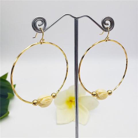 Circular Earrings With An Ivory Color Pikake Flower Bead In Between 2 Gold Beads