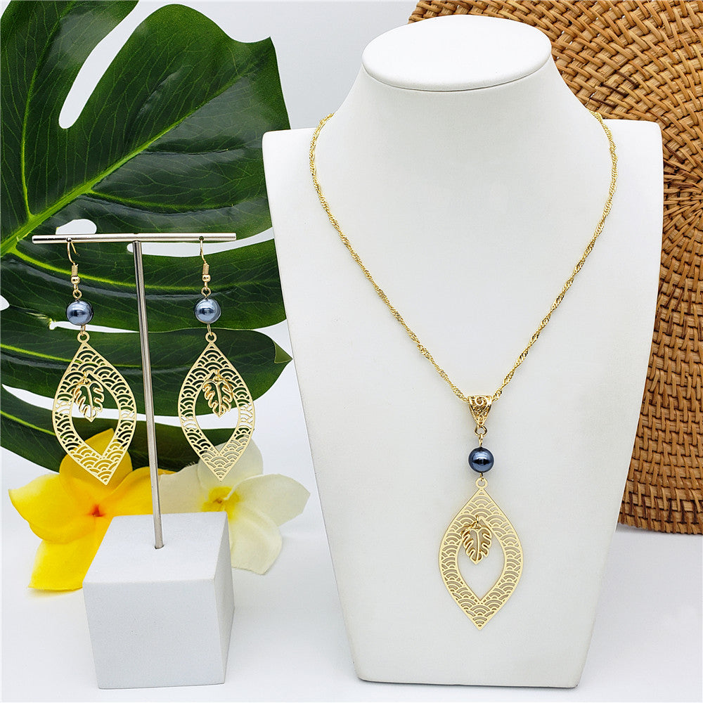 Set Of Carved Waves And Leaf Charm Earrings And Necklace Sustained With A Petrol Pearl And Different Hawaiian Charms